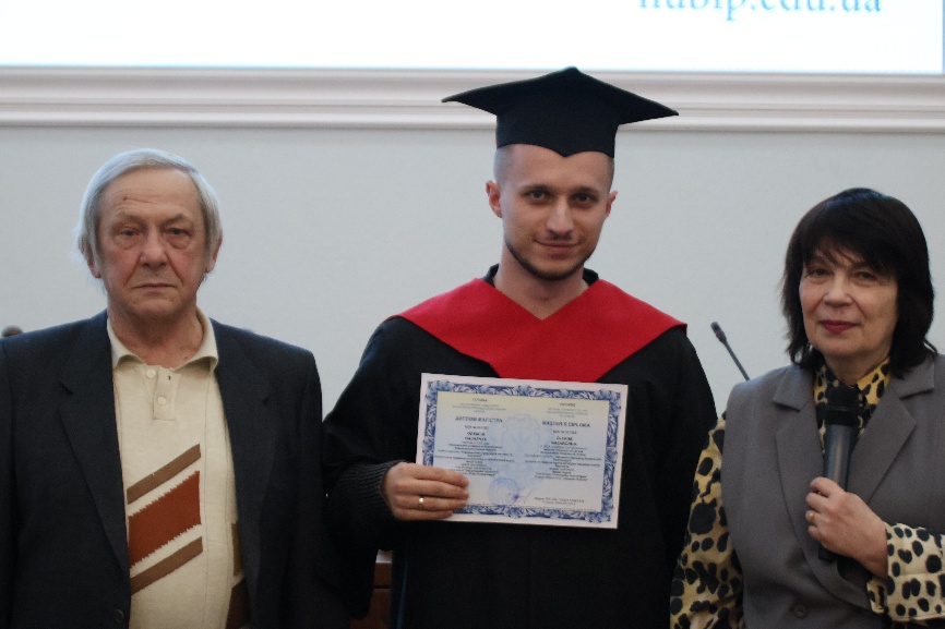 A person in a cap and gown holding a certificate</p>
<p>AI-generated content may be incorrect.