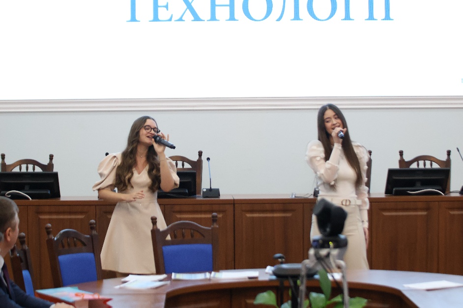 A group of women singing into microphones</p>
<p>AI-generated content may be incorrect.